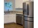 Bright kitchen with stainless steel appliances, white cabinets and granite countertops at 3040 Ivey Oaks Ln, Roswell, GA 30076