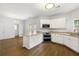 Bright kitchen featuring white cabinetry, granite countertops, and stainless steel appliances at 3040 Ivey Oaks Ln, Roswell, GA 30076