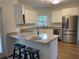 Modern kitchen featuring granite countertops, stainless steel appliances and breakfast bar at 3040 Ivey Oaks Ln, Roswell, GA 30076