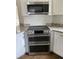 Well-equipped kitchen featuring stainless steel double oven and granite countertops at 3040 Ivey Oaks Ln, Roswell, GA 30076