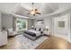 A staged primary bedroom with hardwood floors, a ceiling fan, and ensuite bathroom at 3040 Ivey Oaks Ln, Roswell, GA 30076