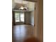 Spacious main bedroom features a tray ceiling, ceiling fan and large windows at 3040 Ivey Oaks Ln, Roswell, GA 30076