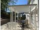 Backyard patio with white pergola and a table with chairs at 3040 Ivey Oaks Ln, Roswell, GA 30076
