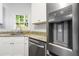 Stainless steel refrigerator with filtered water dispenser in kitchen featuring granite counters and stainless steel appliances at 3040 Ivey Oaks Ln, Roswell, GA 30076
