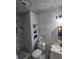 Elegant bathroom with marble tile, stylish fixtures and built-in shelving at 3356 Hollow Ct, Lawrenceville, GA 30044