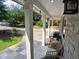 Inviting covered front porch featuring stone accents, a tiled floor, and exterior light fixtures at 3356 Hollow Ct, Lawrenceville, GA 30044