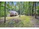 Scenic backyard with a deck, wooded views, and mature trees providing privacy at 3365 Ne Ivy Lake Drive Northeast Dr, Buford, GA 30519