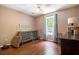 Comfortable bedroom featuring hardwood floors, with bright natural light from the window at 3365 Ne Ivy Lake Drive Northeast Dr, Buford, GA 30519