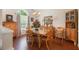 Inviting dining room featuring a glass-top table, wood floors, and a large window at 3365 Ne Ivy Lake Drive Northeast Dr, Buford, GA 30519