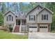 Charming home featuring stone accents, a two-car garage, and a welcoming front porch at 3365 Ne Ivy Lake Drive Northeast Dr, Buford, GA 30519