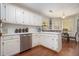 Well-lit kitchen featuring white cabinets, modern appliances, and a breakfast nook at 3365 Ne Ivy Lake Drive Northeast Dr, Buford, GA 30519