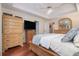 Comfortable main bedroom with a large bed, ceiling fan, and wood floors at 3365 Ne Ivy Lake Drive Northeast Dr, Buford, GA 30519