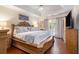 Luxurious main bedroom with a king-size bed, ceiling fan, and a door to the outside at 3365 Ne Ivy Lake Drive Northeast Dr, Buford, GA 30519
