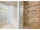 Stylish bathroom features a glass shower enclosure, soaking tub, and linen closet at 4404 Village Field Pl, Suwanee, GA 30024