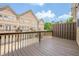 Townhome back deck displaying wood railing, wooden privacy wall, and neighborhood views at 4404 Village Field Pl, Suwanee, GA 30024