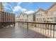 Townhome deck showcasing wood railing, wooden privacy wall, and neighborhood views at 4404 Village Field Pl, Suwanee, GA 30024