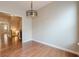 Formal dining room with modern light fixture and hallway view at 4404 Village Field Pl, Suwanee, GA 30024