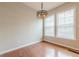 This formal dining area features wood floors, a chandelier and large windows at 4404 Village Field Pl, Suwanee, GA 30024