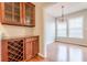 Dining space with wood floors, wine rack and lots of light at 4404 Village Field Pl, Suwanee, GA 30024