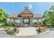 Community entrance with a stone structure, well-maintained landscaping, and clear blue skies at 4404 Village Field Pl, Suwanee, GA 30024