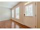 Bright entryway with hardwood floors, neutral walls, and a front door with sidelight windows at 4404 Village Field Pl, Suwanee, GA 30024