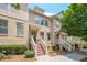 Beautiful townhome featuring a brick and siding exterior, landscaped front yard, and inviting front entrance at 4404 Village Field Pl, Suwanee, GA 30024