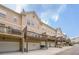 Townhome exterior featuring a garage and balcony with neutral colored facade and blue sky at 4404 Village Field Pl, Suwanee, GA 30024