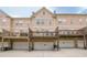 Townhome rear exterior showing private decks, garages, and street level access, offering convenient living at 4404 Village Field Pl, Suwanee, GA 30024