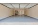 Spacious two car garage with epoxy floor, overhead door hardware, and utilities in the rear at 4404 Village Field Pl, Suwanee, GA 30024