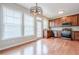 Open concept kitchen with stainless appliances and wood floors at 4404 Village Field Pl, Suwanee, GA 30024