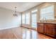 Eat-in-kitchen boasts stylish wooden cabinets and natural light at 4404 Village Field Pl, Suwanee, GA 30024