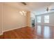 Open-concept living room featuring hardwood floors, a fireplace, and a modern chandelier at 4404 Village Field Pl, Suwanee, GA 30024