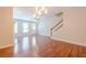 Open living area with hardwood floors, fireplace, staircase, and multiple windows for ample light at 4404 Village Field Pl, Suwanee, GA 30024