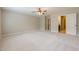 Spacious main bedroom features neutral carpeting, a ceiling fan, and ensuite bathroom access at 4404 Village Field Pl, Suwanee, GA 30024