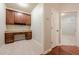 Cozy office space with custom built-ins, drawers, desk, and overhead cabinets providing ample storage and workspace at 4404 Village Field Pl, Suwanee, GA 30024