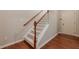Staircase features hardwood floors, a carpet runner, and white risers at 4404 Village Field Pl, Suwanee, GA 30024