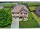 Aerial view of a beautiful two-story home with a large yard in a suburban neighborhood at 206 Traditions Dr, Loganville, GA 30052