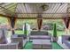 Backyard patio area with stylish outdoor furniture under a gazebo, featuring an organized shed at 206 Traditions Dr, Loganville, GA 30052