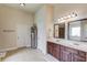 Bright bathroom with a double sink vanity, tile floors, and large mirrors and a separate room for the shower at 206 Traditions Dr, Loganville, GA 30052