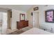 Cozy bedroom with vaulted ceiling, traditional dresser and an adjacent, well-lit hallway at 206 Traditions Dr, Loganville, GA 30052