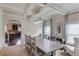 Elegant dining room with a coffered ceiling, stylish lighting, and arched entryway at 206 Traditions Dr, Loganville, GA 30052