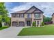 Charming two-story brick home with a two-car garage and well-manicured lawn at 206 Traditions Dr, Loganville, GA 30052