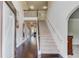 Grand foyer with hardwood floors, a staircase, and an open view of the living spaces at 206 Traditions Dr, Loganville, GA 30052