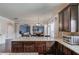 Open kitchen with granite countertops and appliances with view into the dining and living spaces at 206 Traditions Dr, Loganville, GA 30052