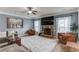 Spacious living room with a stone fireplace, comfortable seating, and ample natural light at 206 Traditions Dr, Loganville, GA 30052