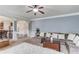 Bright living room featuring a plush sectional sofa, ceiling fan, and decorative accents at 206 Traditions Dr, Loganville, GA 30052