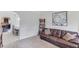 Cozy living room with a leather sofa, bookshelf, and view into the dining area at 206 Traditions Dr, Loganville, GA 30052