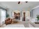 Inviting living room showcasing arched doorways, a cozy armchair, and neutral decor at 206 Traditions Dr, Loganville, GA 30052