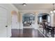 Spacious living area showing dining and living spaces featuring beautiful archways and hardwood floors at 206 Traditions Dr, Loganville, GA 30052