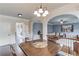 Open-concept living area with hardwood floors and seamless transition to dining and living spaces at 206 Traditions Dr, Loganville, GA 30052